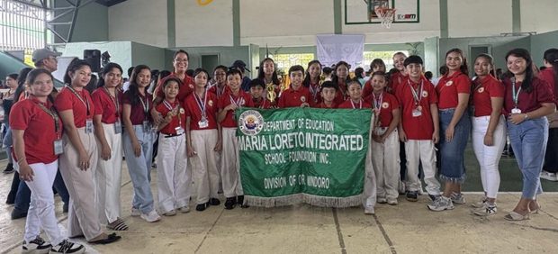 MLISFI delegation with the school banner