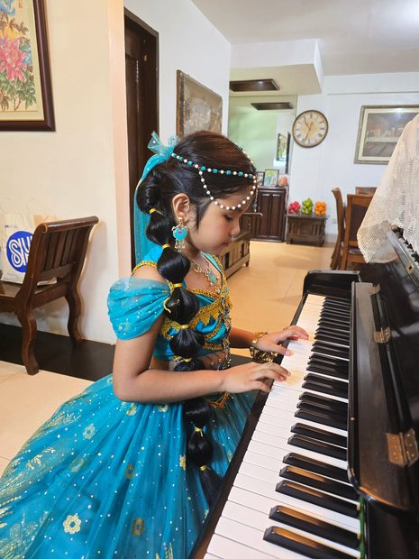 MLISFI pupil at her piano lesson